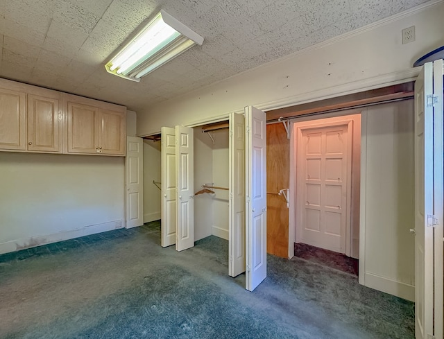 unfurnished bedroom with dark colored carpet