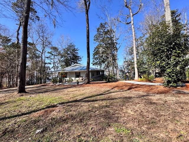 view of yard featuring covered porch