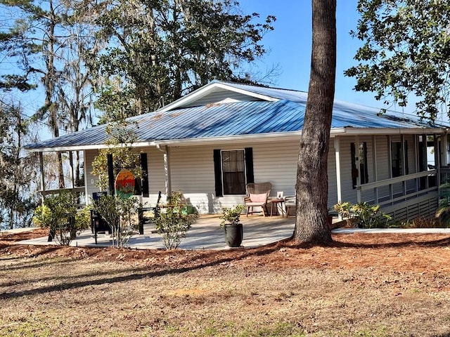 back of property with a porch