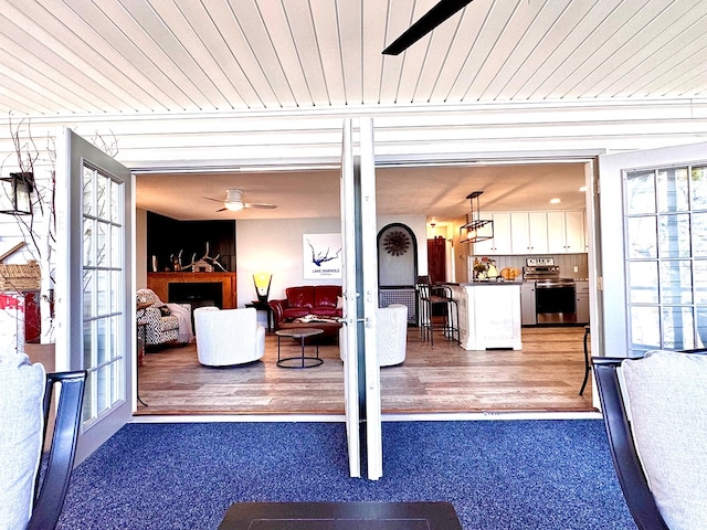 interior space featuring wood ceiling, french doors, and ceiling fan