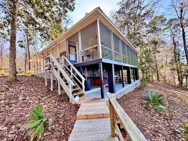 rear view of house with a patio and a sunroom