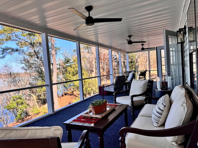 sunroom / solarium featuring ceiling fan