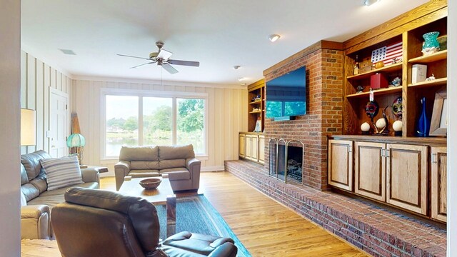 1389 Lake Front Dr, Cairo, GA 39828 - living room featuring a ceiling fan, light wood-type flooring, a brick fireplace, and ornamental molding