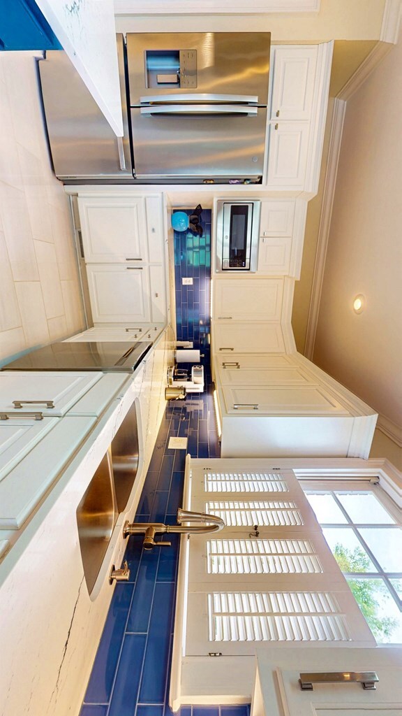 1389 Lake Front Dr, Cairo, GA 39828 - kitchen with tasteful backsplash and white cabinetry