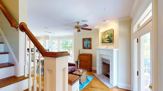 1389 Lake Front Dr, Cairo, GA 39828 - stairway featuring wood finished floors, ornamental molding, ceiling fan, and a fireplace