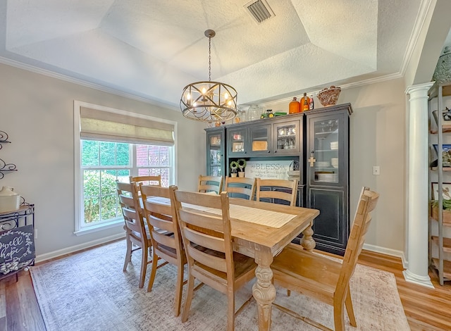 1415 College Rd, Bainbridge, GA 39819 - dining space with a chandelier, light wood-style flooring, decorative columns, ornamental molding, and baseboards