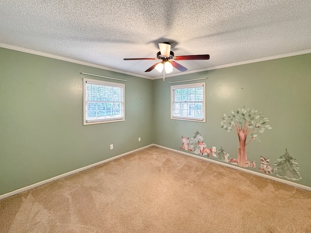 carpeted spare room featuring ornamental molding, ceiling fan, and a textured ceiling