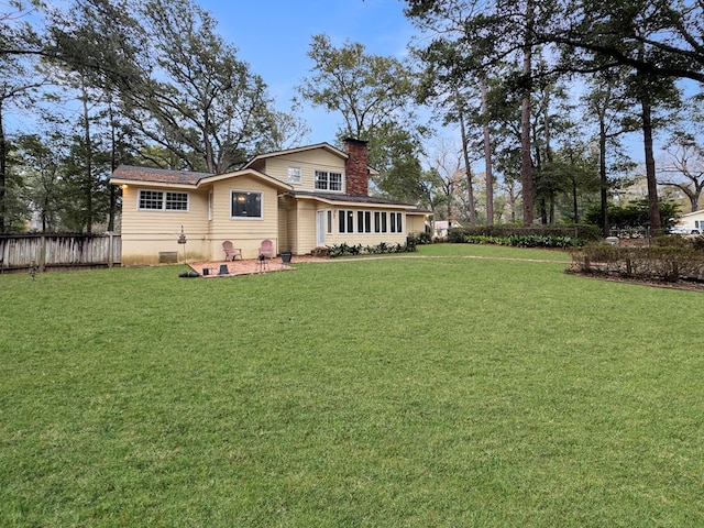 back of house featuring a yard