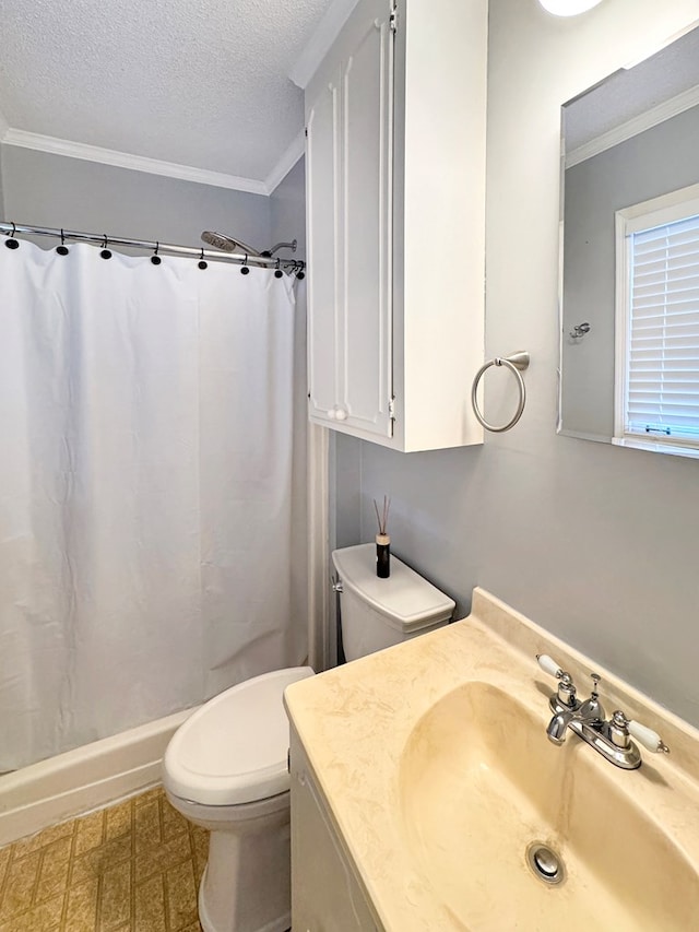 bathroom featuring toilet, vanity, a textured ceiling, and ornamental molding