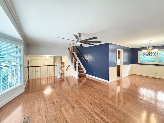 unfurnished living room with plenty of natural light, ornamental molding, and hardwood / wood-style floors