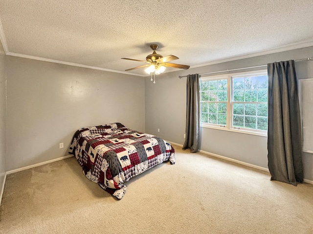 bedroom featuring ceiling fan, crown molding, carpet floors, and a textured ceiling