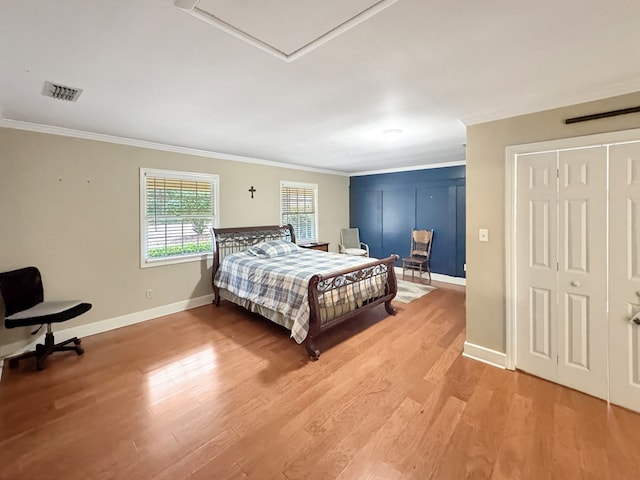 bedroom with crown molding and hardwood / wood-style flooring