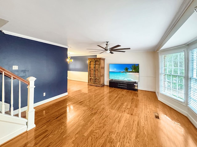 unfurnished living room with ornamental molding, hardwood / wood-style floors, and ceiling fan with notable chandelier