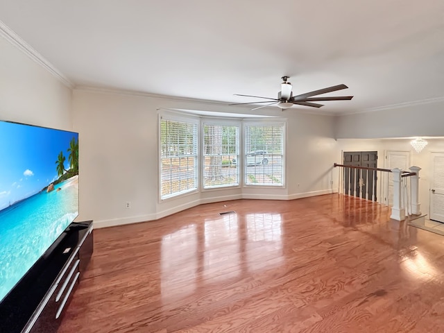 unfurnished living room featuring ceiling fan, ornamental molding, and hardwood / wood-style floors