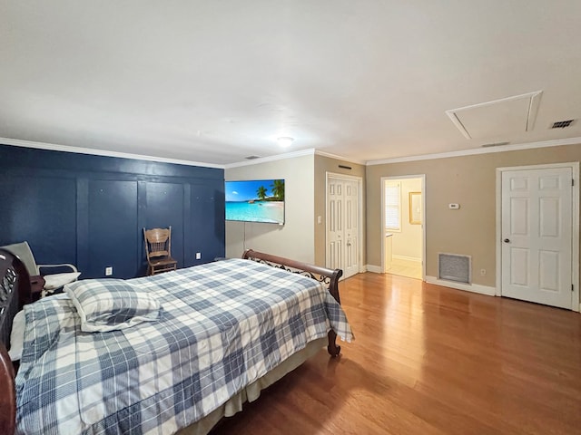 bedroom featuring hardwood / wood-style floors and crown molding