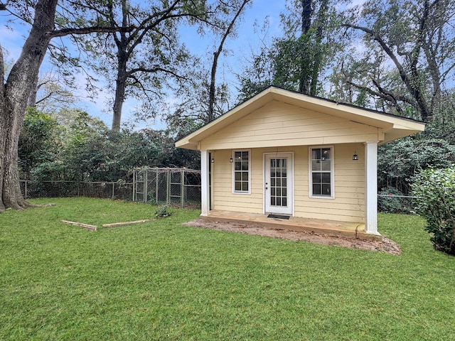 view of outbuilding with a yard