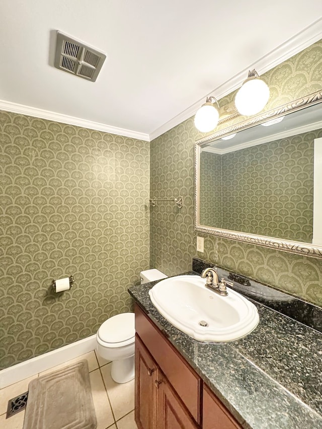 bathroom featuring toilet, vanity, tile patterned floors, and crown molding