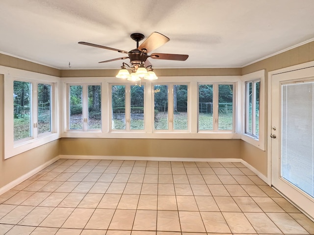 unfurnished sunroom featuring ceiling fan