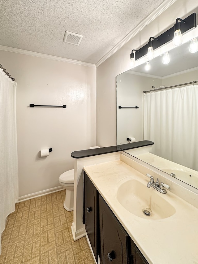 bathroom featuring toilet, a textured ceiling, ornamental molding, and vanity