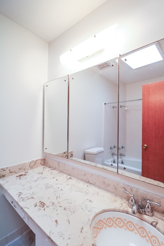 full bathroom featuring shower / bathing tub combination, vanity, and toilet