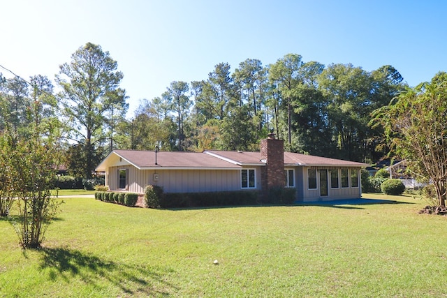 back of house with a lawn