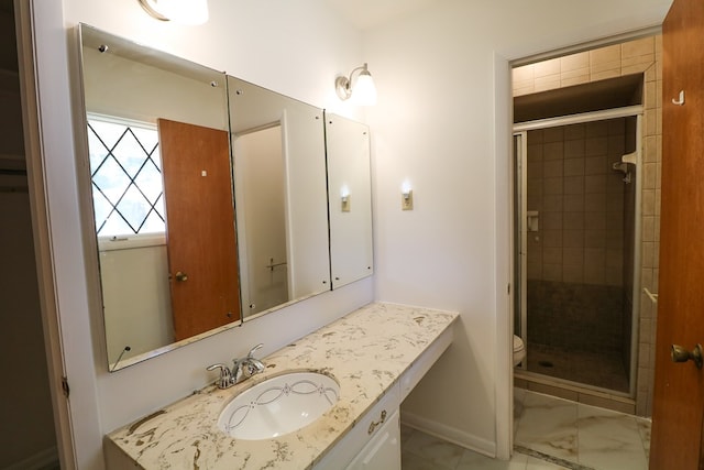 bathroom with a shower with door, vanity, and toilet