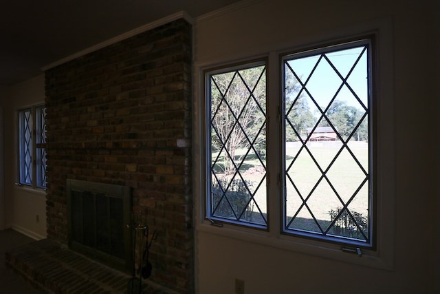 details with crown molding and a brick fireplace