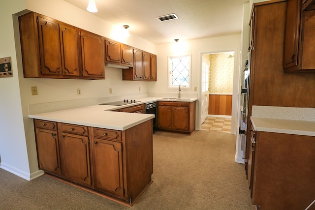 kitchen featuring light carpet, black electric stovetop, sink, a textured ceiling, and kitchen peninsula