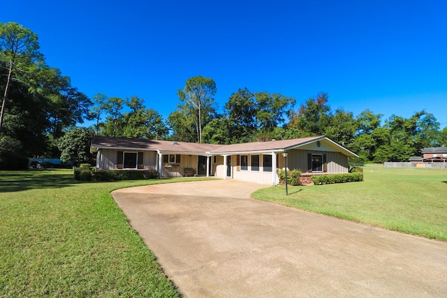 ranch-style home featuring a front yard