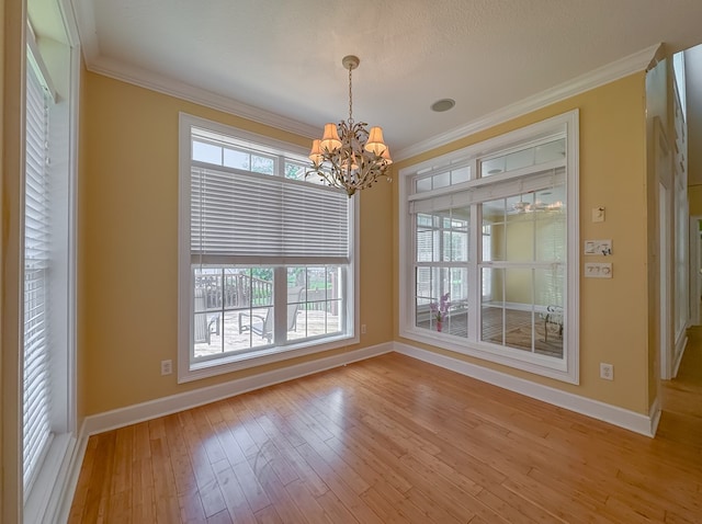 115 Lakeside Ln, Bainbridge, GA 39819 - unfurnished dining area with a chandelier, baseboards, light wood-type flooring, and ornamental molding