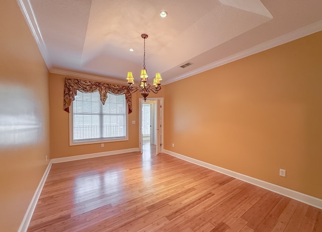 115 Lakeside Ln, Bainbridge, GA 39819 - spare room featuring ornamental molding, a chandelier, light wood finished floors, baseboards, and a tray ceiling