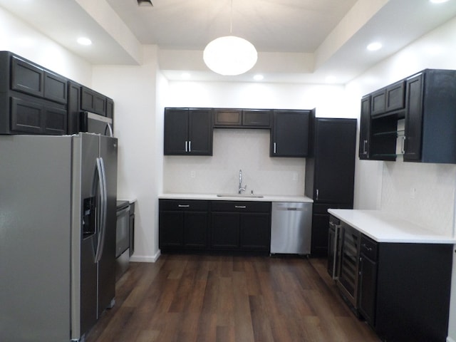 kitchen featuring wine cooler, sink, decorative light fixtures, appliances with stainless steel finishes, and dark hardwood / wood-style flooring