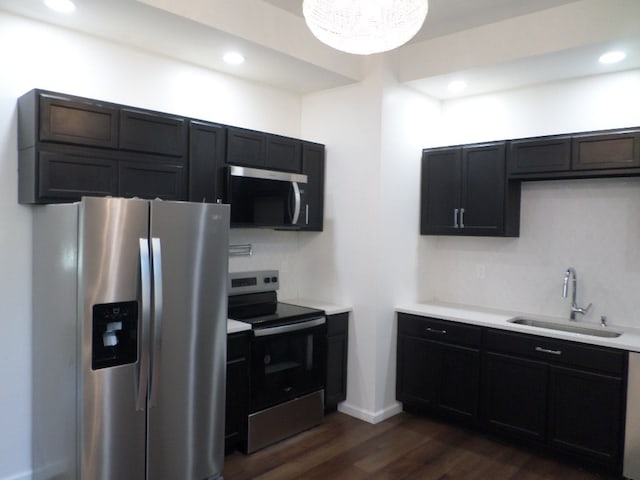 kitchen with stainless steel appliances, sink, and dark hardwood / wood-style floors