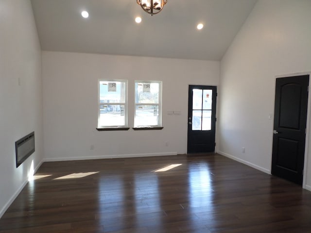 entryway featuring dark hardwood / wood-style floors, heating unit, and high vaulted ceiling