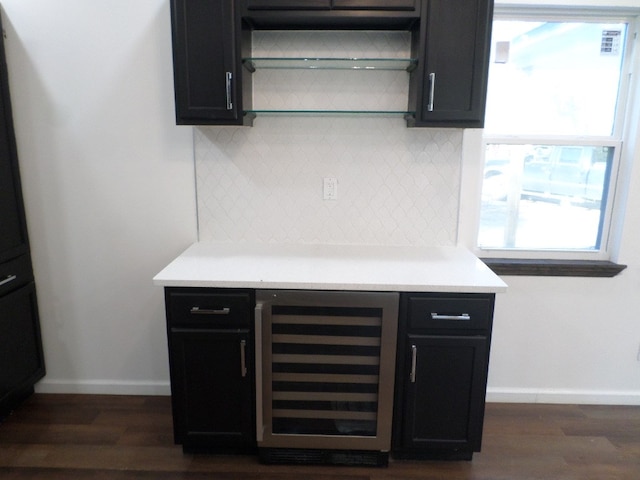 kitchen with tasteful backsplash, dark hardwood / wood-style floors, and beverage cooler