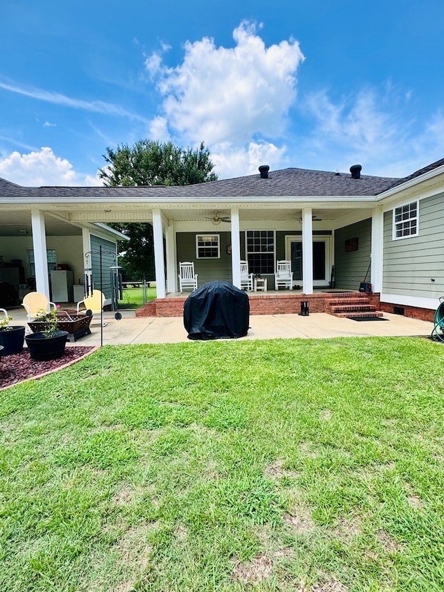 rear view of house with a lawn and a patio area