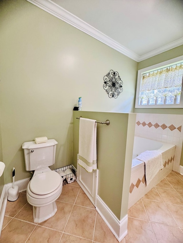 bathroom featuring tile patterned flooring, toilet, crown molding, and tiled tub