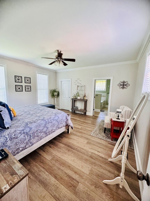 bedroom featuring ceiling fan, wood-type flooring, and ornamental molding