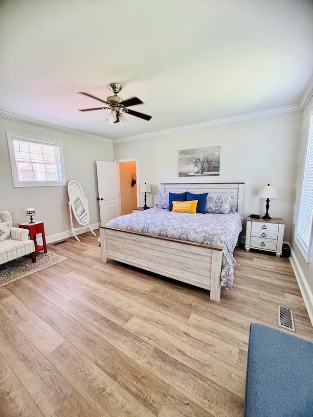 bedroom featuring hardwood / wood-style flooring, ceiling fan, and crown molding