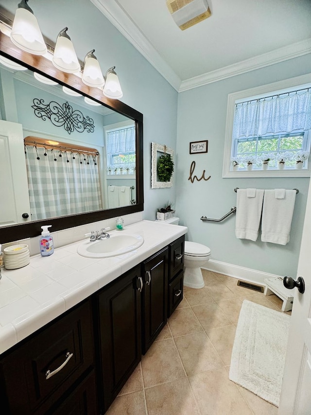 bathroom featuring tile patterned floors, crown molding, vanity, and toilet