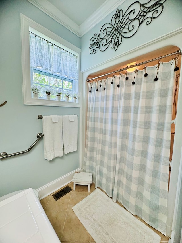 bathroom with crown molding and tile patterned flooring