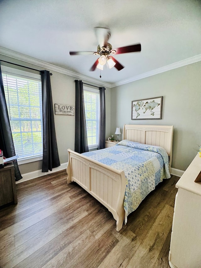 bedroom featuring hardwood / wood-style flooring, ceiling fan, and crown molding