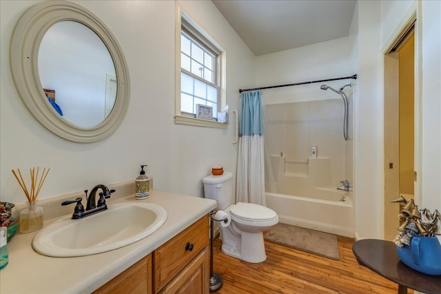 full bathroom with toilet, shower / tub combo, wood finished floors, and vanity