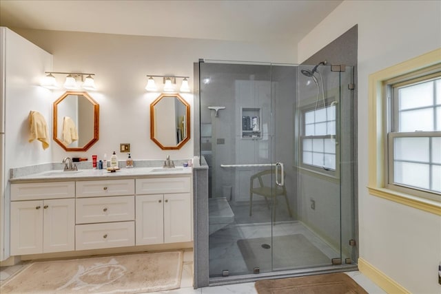 bathroom featuring a stall shower and a sink