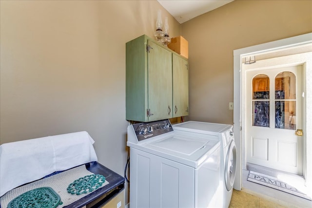 washroom featuring washing machine and dryer and cabinet space