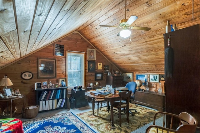 dining room with lofted ceiling, wooden ceiling, wood walls, and ceiling fan