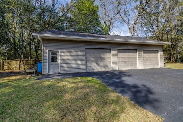 detached garage featuring fence