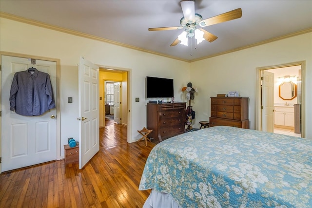 bedroom with ornamental molding, a ceiling fan, and hardwood / wood-style flooring