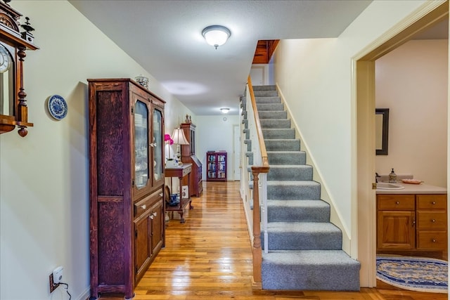 foyer entrance featuring light wood-style floors and stairs