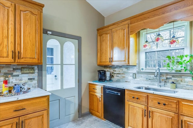 kitchen featuring black dishwasher, light tile patterned floors, decorative backsplash, brown cabinetry, and a sink